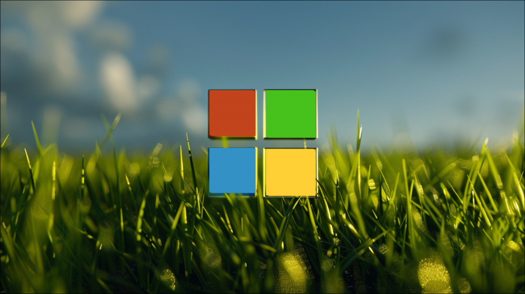 Ein Microsoft-Logo in einem grünen Grasfeld, mit einem blauen Himmel im Hintergrund