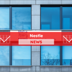 ein Gebäude mit vielen Fenstern und einem Nestlé-Schild mit dem Slogan Good food, Good life, mit einem Nestle NEWS Banner