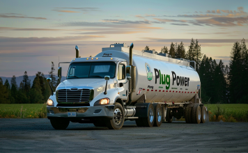 ein weißer Tankwagen mit dem Plug Power-Logo, geparkt in ländlicher Umgebung mit Bäumen im Hintergrund