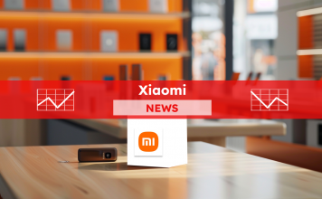 ein Werbedisplay mit einem Würfel mit dem Xiaomi-Logo in einem Ladenumfeld, mit elektronischen Geräten im Hintergrund, mit einem Xiaomi NEWS-Banner