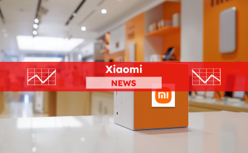 Ein Würfel mit dem Xiaomi-Logo in einem Ladenumfeld, mit elektronischen Geräten im Hintergrund, mit einem Xiaomi NEWS-Banner