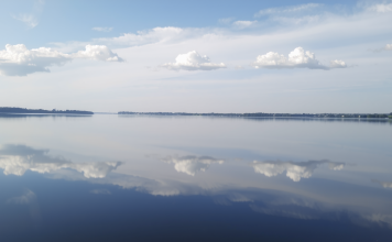 Ruhiger See spiegelt wolkenlosen Himmel